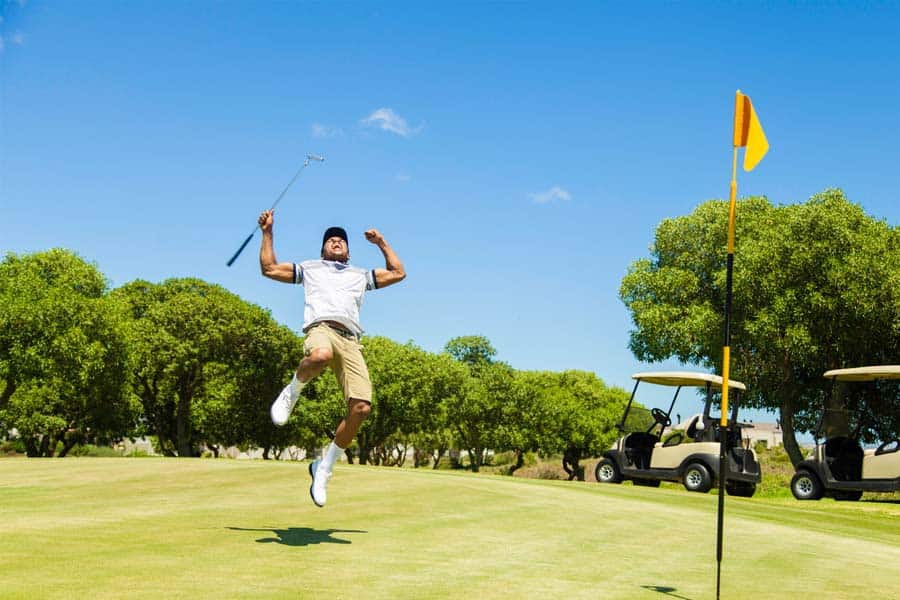 A golfer jumping in happiness on hitting albatross