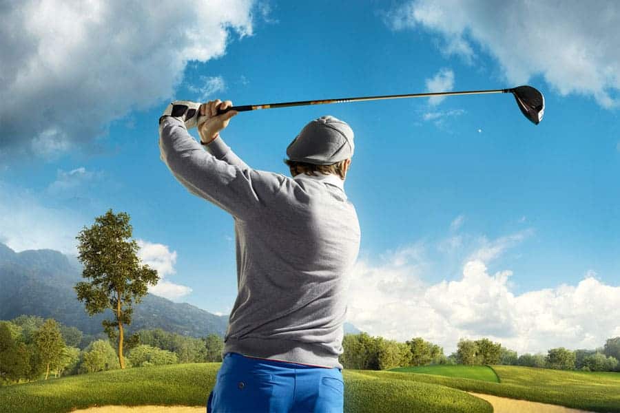 A golfer is hitting the golf ball straight with the help of a driver.