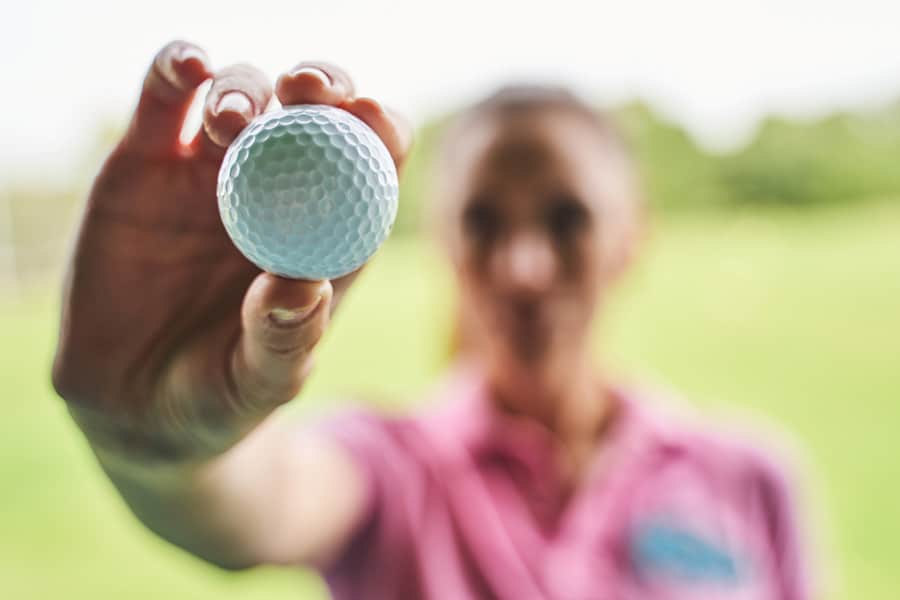 A golfer is showcasing the golf ball