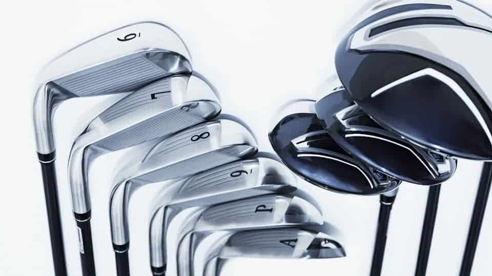 A set of golf clubs such as irons, approach wedge, pitching wedge, drivers, and hybrids are displayed in the image.