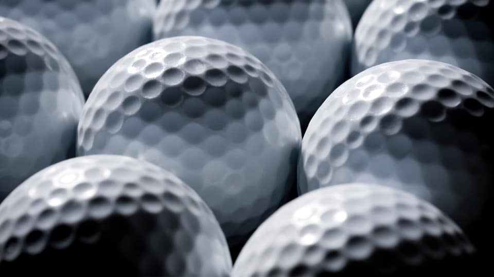 Dimples, the small depressions visible on the cover of the golf ball