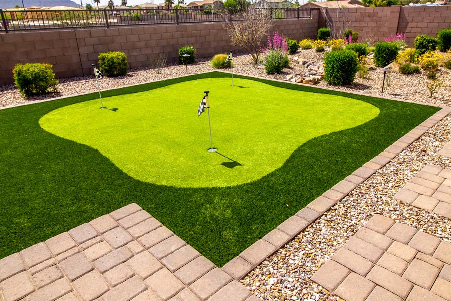 A set up of putting green in the backyard of a house.